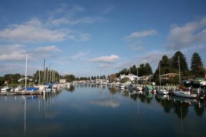 a bunch of boats are docked in a harbor at Coach House in Port Fairy