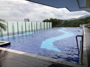 a swimming pool with blue water on top of a building at Dream of the summer Ipoh in Ipoh