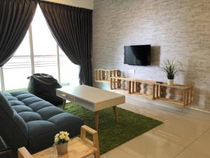 a living room with a couch and a tv at Dream of the summer Ipoh in Ipoh