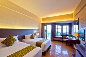 Kama o mga kama sa kuwarto sa Thistle Port Dickson Resort