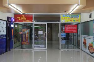 a store with glass doors and signs in a building at Chill Chill at Nimman in Chiang Mai