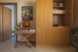 a room with a wooden table and a wooden cabinet at Avantgarde Hotel in Conversano