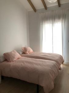 a bedroom with a large bed with a window at La Casa de las Tias in Villanueva de Córdoba +13 photos