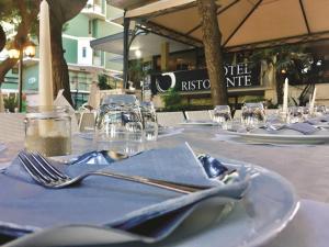 a table set up for a meal at a restaurant at Hotel La Perla Preziosa in Grottammare