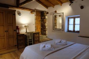a bedroom with a bed with two towels on it at Linos Traditional Cottage in Theológos