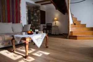 a living room with a table and a couch at Linos Traditional Cottage in Theológos