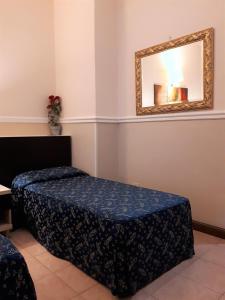 Łóżko lub łóżka w pokoju w obiekcie Hotel Sweet Home