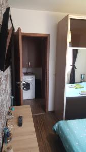 a room with a bed and a room with a kitchen at Apartament Brenda Sibiu in Sibiu