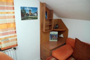 a room with a chair and a book shelf at Ferienwohnung Haus Staffelbergblick in Bad Staffelstein