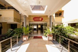 a hallway of a shopping mall with potted plants at Waridi Paradise Hotel and Suites in Nairobi