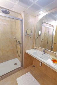 a bathroom with a shower and a sink at Hotel Aqua in Marmaris