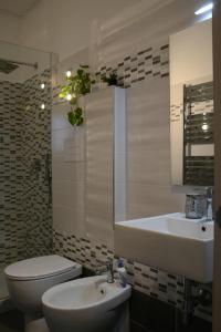 a bathroom with a toilet and a sink and a tub at Appartamento Sole&Luna in Sulmona +38 photos
