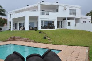 a house with a swimming pool in front of it at 34 on Milkwood in Durban