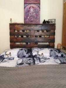 łóżko z drewnianym zagłówkiem w sypialni w obiekcie Studio Karma w Budapeszcie