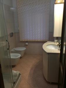 a bathroom with a toilet and a sink at Villa Althea in Ronago +45 photos