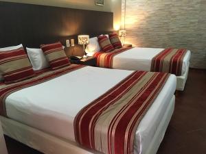 Una cama o camas en una habitación de Hotel Posada La Sorgente