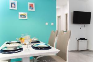 a dining room table with chairs and a television at S&S SPLIT APARTMENT in Split