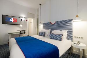 a hotel room with a large bed and a tv at Hotel 34B - Astotel in Paris