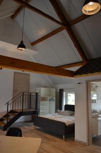 a bedroom with a bed and a staircase in a room at Beim Hooch "Christ" in Brücktal