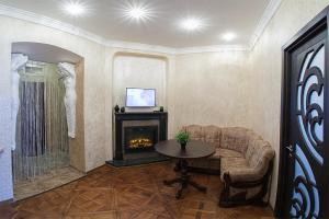 a living room with a couch and a fireplace at Rynok Square - the heart of Lviv in Lviv