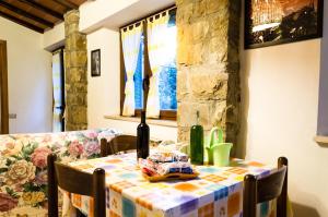 a dining room table with a table cloth on it at San Martino - Casa Landi in Castellina in Chianti