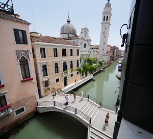a large body of water with a clock tower at Hotel Casa Nicolò Priuli in Venice