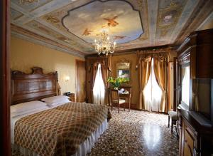 a bedroom with a large bed and a large window at Hotel Casa Nicolò Priuli in Venice