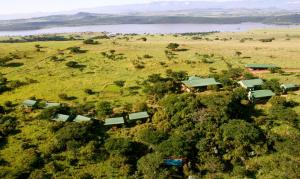 an aerial view of a house on a hill next to a river at Three Tree Hill Lodge in Bergville