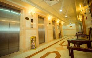 a lobby with a elevator in a building at Anwar Al Zahraa Hotel in Al Madinah