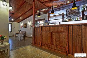 a bar in a restaurant with a wooden wall at Casale Del Vento in Aprilia