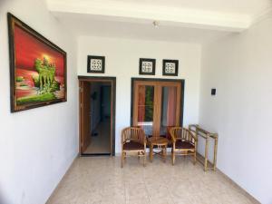a dining room with a table and two chairs at Uluwatu Made Guesthouse in Uluwatu