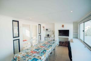 a room with a long table in a room at 20 Cayman Beach, Gordon's Bay in Gordonʼs Bay