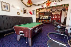 a room with a pool table and a bar at Belmont Hotel in Blackpool