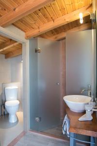 a bathroom with a sink and a toilet at Pantanassa Villa Thalia in Agia Marina Nea Kydonias +21 photos
