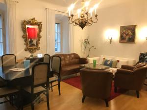 a living room with a table and a couch at The Barts City Center - Self Check-in in Vienna
