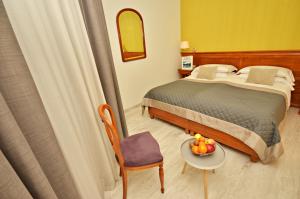 A bed or beds in a room at Hotel Diana Jardin et Spa