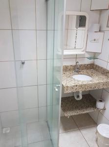 a bathroom with a shower and a sink and a toilet at Telma Hotel in Bauru