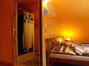 a bedroom with a bed in a room with a mirror at Agroturystyka Zacisze Czarna Owca in Brzeżanka +35 photos
