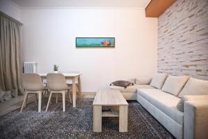 a living room with a couch and a table at Paradise Apartment in Peiraiki in Piraeus