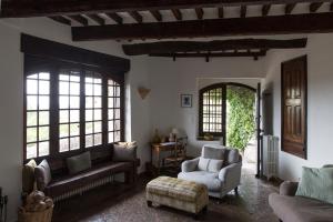 a living room with a couch and chairs and windows at La Miette in Vence