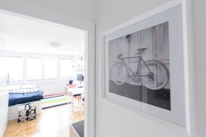 a bike hanging on a wall in a living room at ★★★Urban Zen Haven | Free parking+Bikes+Coffee★★★ in Ljubljana