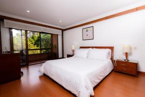 Cama o camas de una habitación en Travelers Condominio Plenitud