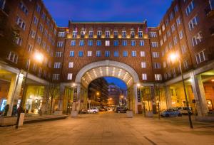 a building with an archway in a city at night at Arcadia Hotel Budapest in Budapest