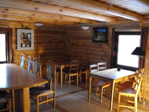 a dining room with wooden tables and chairs at Agroturystyka Zacisze Czarna Owca in Brzeżanka