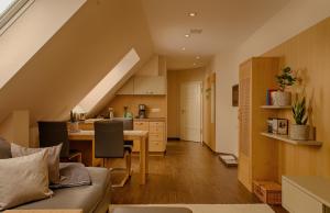 an attic kitchen and living room with a couch and a table at Schrebenza in Burg Kauper