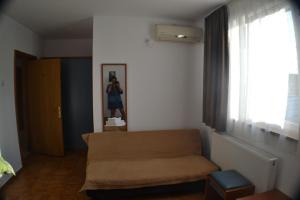 a living room with a couch and a window at Casa Omer in Eforie Nord