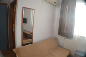 a living room with a couch and a mirror at Casa Omer in Eforie Nord