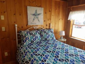 a bedroom with a bed with a blue at Atlantis Motel in Old Orchard Beach