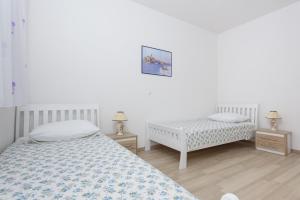 Postel nebo postele na pokoji v ubytování Apartments & Rooms Seaside