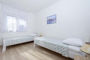 Postel nebo postele na pokoji v ubytování Apartments & Rooms Seaside